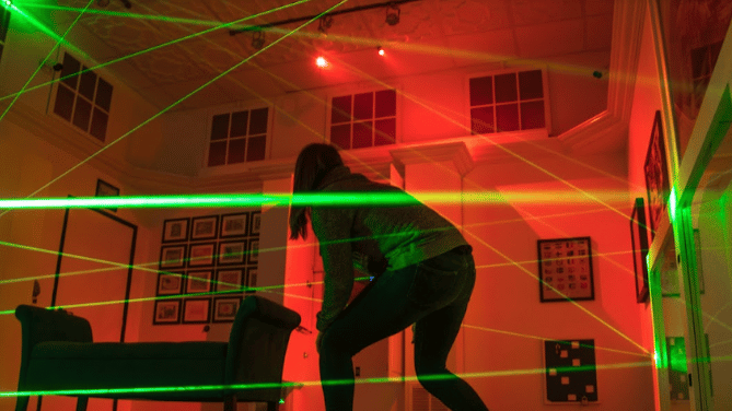 child participating in escapology laser beam room