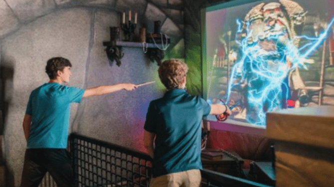 two children holding wands inside magi quest in pigeon forge
