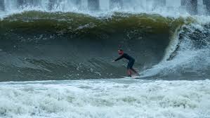 surfer surfing in jacksonville beach in florida