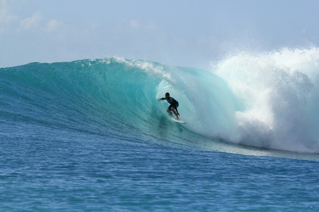 surfer surfing on new smyrna beach